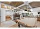 Open floor plan with sliding barn door, wood ceiling, pool table, and easy access to the kitchen at 160 Point O Woods Dr, Daytona Beach, FL 32114