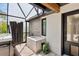 This screened-in outdoor spa area has a jacuzzi and shower with brick and wood accents, creating a tranquil retreat at 160 Point O Woods Dr, Daytona Beach, FL 32114