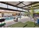 Covered patio with a putting green, lounge seating and outdoor dining, ideal for relaxation and backyard enjoyment at 160 Point O Woods Dr, Daytona Beach, FL 32114