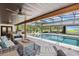 Screened-in pool area complete with outdoor furniture, a dining table, and a BBQ area for outdoor entertainment at 160 Point O Woods Dr, Daytona Beach, FL 32114