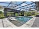Stunning screened-in pool with chaise lounges and a putting green, ideal for relaxation and outdoor fun at 160 Point O Woods Dr, Daytona Beach, FL 32114