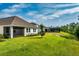 Beautiful backyard view of the property, highlighting the green lawn, trees, and screened-in patio at 16241 Honey Harvest St, Winter Garden, FL 34787