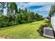 Expansive backyard with a gentle slope, mature trees, and well-maintained landscaping at 16241 Honey Harvest St, Winter Garden, FL 34787