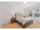 Cozy bedroom with neutral tones, padded headboard, matching nightstands, and bright, sunlit windows at 16241 Honey Harvest St, Winter Garden, FL 34787