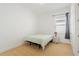 Simple bedroom features neutral carpet, single bed, and bright, sunlit windows at 16241 Honey Harvest St, Winter Garden, FL 34787