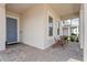 Welcoming front porch with brick flooring, comfortable seating, and a view of the friendly neighborhood at 16241 Honey Harvest St, Winter Garden, FL 34787