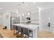 Spacious kitchen with stainless appliances, island seating, hardwood floors, and an open layout to the living area at 16241 Honey Harvest St, Winter Garden, FL 34787