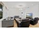 Bright living room with wood floors, stylish light fixture, comfortable seating, and large-screen television at 16241 Honey Harvest St, Winter Garden, FL 34787