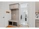 Functional mudroom with a built-in bench, storage cabinets, and coat hooks for organization at 16241 Honey Harvest St, Winter Garden, FL 34787