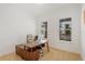 Bright home office with a wooden desk, neutral chair, and large windows providing ample natural light at 16241 Honey Harvest St, Winter Garden, FL 34787