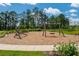 Well-maintained community playground with swings, climbing structures, and lush landscaping at 16241 Honey Harvest St, Winter Garden, FL 34787