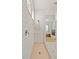 Shower features white subway tile surround, glass door, shower head, and white and peach tile flooring at 16241 Honey Harvest St, Winter Garden, FL 34787