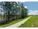 Scenic community walking path along a pond surrounded by lush green landscaping at 16241 Honey Harvest St, Winter Garden, FL 34787