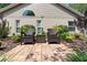 Cozy brick back patio with outdoor seating, surrounded by lush landscaping for a private and relaxing retreat at 1637 Bent Oaks Blvd, Deland, FL 32724