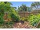 Backyard landscape with a charming wind spinner, bird bath, and colorful flowers, adding a whimsical touch at 1637 Bent Oaks Blvd, Deland, FL 32724