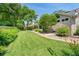 Spacious backyard featuring green lawn and mature landscaping along the side of the house at 1637 Bent Oaks Blvd, Deland, FL 32724