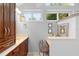 Bathroom area with vanity, chair, lots of lights, big mirror and windows at 1637 Bent Oaks Blvd, Deland, FL 32724