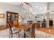 Dining room featuring a glass display cabinet, hardwood floors, and views of the kitchen at 1637 Bent Oaks Blvd, Deland, FL 32724