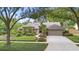 Traditional home with a manicured lawn and mature landscaping at 1637 Bent Oaks Blvd, Deland, FL 32724
