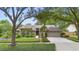 Charming single-story home with a well-maintained lawn, mature trees, and an attached two-car garage at 1637 Bent Oaks Blvd, Deland, FL 32724