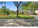 Well-maintained home exterior with mature trees and manicured landscaping along street at 1637 Bent Oaks Blvd, Deland, FL 32724