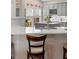 Charming kitchen featuring a breakfast bar with seating, bright countertops, and gray cabinets at 1637 Bent Oaks Blvd, Deland, FL 32724