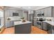 Modern kitchen with gray cabinets, stainless steel appliances, and a central island at 1637 Bent Oaks Blvd, Deland, FL 32724