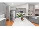 Well-equipped kitchen featuring gray cabinets, stainless steel appliances, and a farmhouse sink at 1637 Bent Oaks Blvd, Deland, FL 32724