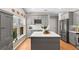 Well-lit kitchen featuring gray cabinets, stainless steel appliances, and a center island at 1637 Bent Oaks Blvd, Deland, FL 32724