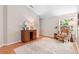 Inviting living room featuring a comfortable armchair, stylish cabinet, and natural light from the window at 1637 Bent Oaks Blvd, Deland, FL 32724