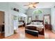 This main bedroom is big, and has a ceiling fan, a big window, and sliding mirror closet doors at 1637 Bent Oaks Blvd, Deland, FL 32724
