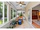 The sunroom with lots of big windows, a ceiling fan, and an exit to the backyard at 1637 Bent Oaks Blvd, Deland, FL 32724