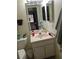 Well-lit bathroom featuring a vanity, toilet, and mirror, providing a clean and functional space at 1640 Juno Trl # 103F, Astor, FL 32102