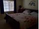 Cozy bedroom featuring a comfortable bed, window with natural light, and tasteful decorations at 1640 Juno Trl # 103F, Astor, FL 32102