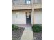 Inviting condo front door with a welcome mat, set in a garden-style community at 1640 Juno Trl # 103F, Astor, FL 32102