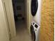 Close-up of in-unit washer and dryer next to a hallway at 1640 Juno Trl # 103F, Astor, FL 32102