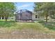 Spacious backyard showcasing a screened lanai and lush green lawn at 171 Birchmont Dr, Deland, FL 32724