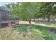 Spacious backyard with lush lawn, mature trees, and views of the golf course at 171 Birchmont Dr, Deland, FL 32724