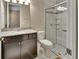 Well-lit bathroom featuring a granite countertop and a glass-door shower with tile surround at 171 Birchmont Dr, Deland, FL 32724