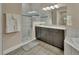 Bathroom featuring a walk-in shower, dark wood cabinets, granite counters and decorative mirror at 171 Birchmont Dr, Deland, FL 32724