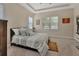 Cozy bedroom with tray ceilings, two windows and carpeted floors at 171 Birchmont Dr, Deland, FL 32724
