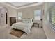 Comfortable bedroom with tray ceiling, plush carpet, and window views at 171 Birchmont Dr, Deland, FL 32724