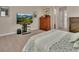 Cozy bedroom featuring soft carpeting, a comfortable bed, and entertainment center at 171 Birchmont Dr, Deland, FL 32724