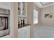 Bright dining area with a built in bar, granite countertop, white cabinets, and white tiled floor at 171 Birchmont Dr, Deland, FL 32724