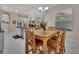 Open-concept dining room with a wood table, chairs, tile flooring, and view of the kitchen and living room at 171 Birchmont Dr, Deland, FL 32724