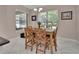 Dining room with a wooden table, chairs, tiled flooring, and a view of the backyard and pool at 171 Birchmont Dr, Deland, FL 32724