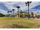 Inviting building exterior with outdoor dining, lush green lawn, and towering palm trees at 171 Birchmont Dr, Deland, FL 32724
