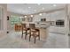 Modern kitchen with an island, granite countertops, stainless steel appliances, and eat-in dining area at 171 Birchmont Dr, Deland, FL 32724