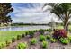 Picturesque lake view with manicured landscaping and vibrant foliage at 171 Birchmont Dr, Deland, FL 32724