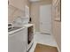 Functional laundry room with white front-load washer and dryer, and tile flooring at 171 Birchmont Dr, Deland, FL 32724